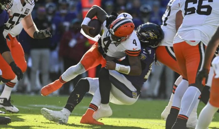 Jadeveon Clowney (in purple) drags down Deshaun Watson during Sunday's AFC North tilt